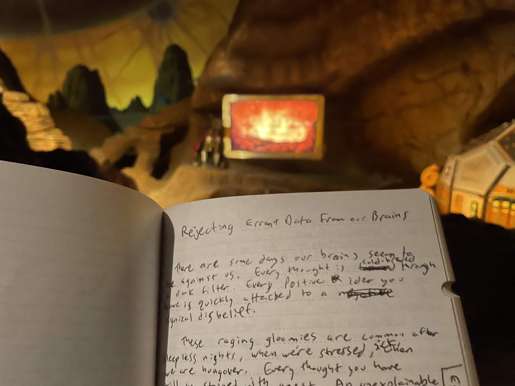 One of the Space Mountain exit tunnels dioramas with the RCA Robot Dog next to a screen with space vacations advertisements. An open journal in the foreground.